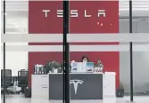  ?? NG HAN GUAN THE ASSOCIATED PRESS ?? U.S.-based activists are appealing to Tesla to close a new showroom in Xinjiang where officials are accused of abuses against mostly Muslim ethnic minorities.