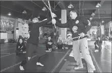  ?? PROVIDED TO CHINA DAILY ?? Frank Olea (right) practices with another Filipino martial arts practition­er in a gym in Lanzhou, Gansu province.