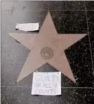  ??  ?? Bill Cosby’s star on the Hollywood Walk Fame is tagged with a “Guilty on All 3 Counts!” papers in Los Angeles.