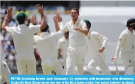  ?? — AFP ?? PERTH: Australian bowler Josh Hazlewood (C) celebrates with teammates after dismissing England’s Mark Stoneman on day four of the third Ashes cricket Test match between Australia and England in Perth yesterday.