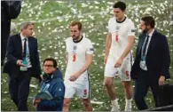  ?? (AFP) ?? England’s forward Harry Kane (C-L) and defender Harry Maguire (C-R) leave the pitch after the trophy ceremony at the Wembley Stadium in London on Sunday.