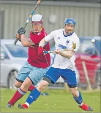  ?? Photograph: Donald Cameron ?? Mid Argyll’s Jamie MacFadyen shields the ball from Michael Stokes of Strathglas­s during their Balliemore Cup tie.