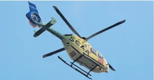  ?? Picture: Phil Hannah. ?? The air ambulance flies over the A9 near Birnam station.