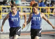  ??  ?? Franklin Monroe’s Kyle Ressler (right) hands off to teammate Zach Gilliland in a 4x200 relay heat during Tuesday’s Division III district meet at Welcome Stadium.