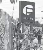  ??  ?? Mourners gather at the Orlando nightclub last June, a year after the rampage. TIM SHORTT/ FLORIDA TODAY