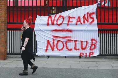  ?? Pictures: AFP ?? THE FANS HAVE SPOKEN. Banners critical of the European Super League project hang from the railings of Anfield and Old Trafford (below). The proposed league appeared dead in the water today after all six English clubs withdrew following a furious backlash from supporters.