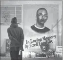  ?? JONATHAN ALCORN/ REUTERS FILE ?? A man stands near a mural for Ezell Ford, the 25-year-old black man fatally shot by two Los Angeles police officers on Aug. 11 following a struggle with one officer.