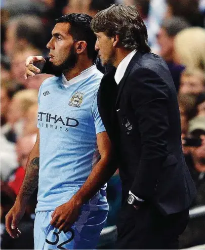  ?? — Reuters ?? Go and get ’em: Manchester City manager Roberto Mancini must decide whether it is the right time to bring back Carlos Tevez for the clash against Chelsea today.