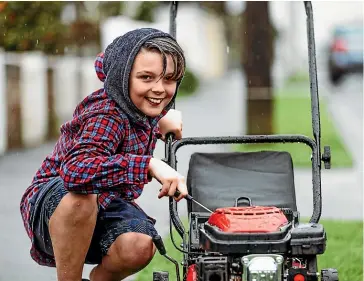  ?? VANESSA LAURIE/STUFF ?? Kayden Potroz-Wallis, 11, has set up his own lawnmowing business as he wants to start early getting into contractin­g. He charges $35 per lawn.