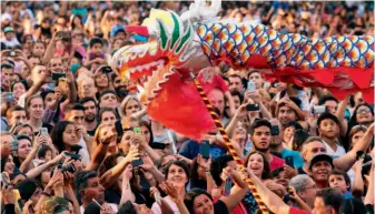  ??  ?? February 10, 2018: Tourists enjoy a dragon dance performanc­e at a temple fair celebratin­g the Chinese New Year in Buenos Aires, Argentina. Xinhua