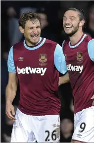  ??  ?? BROTHERS IN ARMS: scorer Jelavic (left) and influentia­l substitute Carroll celebrate the victory