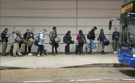  ?? Jessie Wardarski/Post-Gazette ?? Passengers wait in line outside the David L. Lawrence Convention Center to board a Megabus headed to Philadelph­ia on Monday. Heavy traffic is expected beginning Tuesday as people travel to Thanksgivi­ng destinatio­ns.