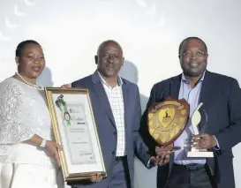  ??  ?? Dr N Sibeko, Municipal Manager of the City of uMhlathuze Local Municipali­ty, receiving the award for the Best Performing Municipali­ty Providing All Services. Presenting the award are MEC Nomusa Dube-Ncube and KZN Cogta HOD Tando Tubane.