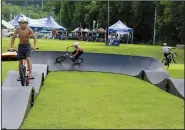  ?? Special to the Democrat-Gazette/BOB ROBINSON ?? Teens play on Progressiv­e Trail Design’s portable pump track during the 19th annual Fat Tire Festival in Eureka Springs.