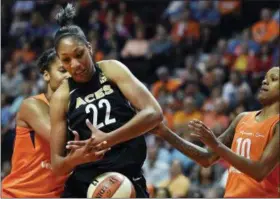  ?? SEAN D. ELLIOT — THE DAY VIA AP, FILE ?? In this file photo, Las Vegas Aces forward A’ja Wilson (22) tries to get a rebound between Connecticu­t Sun forward Alyssa Thomas, left, and guard Courtney Williams during a WNBA basketball game Sunday in Uncasville, Conn.