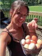  ?? PHOTO COURTESY OF KIM ADCOCK ?? Kim Adcock holds up a basket of chicken eggs she planned to take to the farmer’s market.