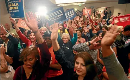  ?? AP ?? Democratic supporters cheer their candidates at a Democratic Party victory celebratio­n in Richmond, Virginia.