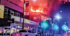  ??  ?? Flames erupt from the building. Picture: Fire & Rescue NSW