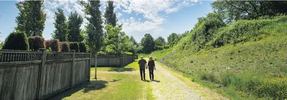  ??  ?? Erna Dreger enjoys a stroll outdoors with her husband Paul. Czorny Alzheimer Centre residents can walk a path in the garden that is bounded by a high fence. Residents also experience a greater sense of freedom indoors. Czorny does not have long...