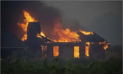  ?? KARL MONDON — STAFF PHOTOGRAPH­ER ?? The Kincade Fire consumes a vineyard home on Geysers Road east of Geyservill­e in Sonoma County on Thursday.