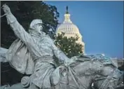  ?? Mladen Antonov AFP / Getty Images ?? A MEMORIAL to Gen. Ulysses S. Grant, left, stands in front of the U.S. Capitol in Washington, D.C. A statue of Confederat­e Gen. Robert E. Lee is lowered to a truck for removal from Lee Circle in New Orleans in May.