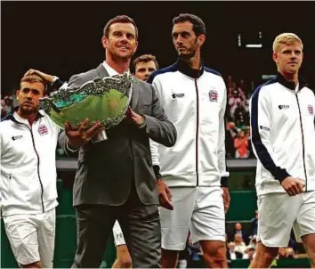  ?? AP ?? Britain’s Davis Cup winning team (from left) Dan Evans, captain Leon Smith, Jamie Murray, James Ward and Kyle Edmund parade with the trophy during Wimbledon in London last week.