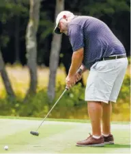  ?? STAFF PHOTO BY C.B. SCHMELTER / ?? Richard Spangler putts on the 16th green during the Chattanoog­a Men’s Metro golf tournament Sunday at The Course at McLemore in Rising Fawn, Ga.