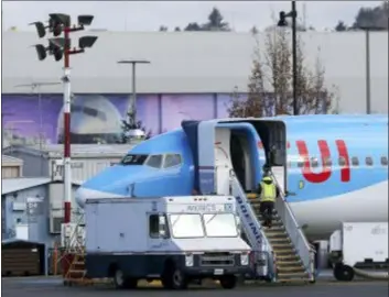  ?? TED S. WARREN — THE ASSOCIATED PRESS ?? A worker walks up steps to the right of an avionics truck parked next to a Boeing 737 MAX 8 airplane being built for TUI Group at Boeing Co.’s Renton Assembly Plant Wednesday in Renton, Wash. President Donald Trump says the U.S. is issuing an emergency order grounding all Boeing 737 Max 8 and Max 9 aircraft in the wake of a crash of an Ethiopian Airliner.
