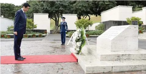  ?? — Reuters ?? Japanese Prime Minister Shinzo Abe presents a wreath at the National Memorial Cemetery of the Pacific at Punchbowl in Honolulu, Hawaii.