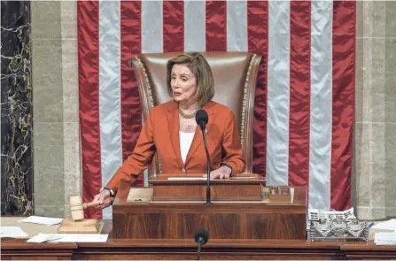  ?? PHOTOS BY J. SCOTT APPLEWHITE/AP ?? House Speaker Nancy Pelosi announces the passage of the gun safety bill on Friday. She underscore­d its significan­ce to her party by taking the unusual step of presiding over the vote and announcing the result from the podium.