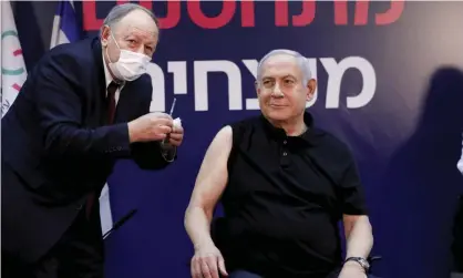  ?? Photograph: Amir Cohen/AP ?? Israel’s prime minister, Benjamin Netanyahu, receiving a Covid-19 vaccine on Saturday.