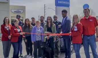  ?? ?? Anthony Brownlee cuts ribbon at grand opening of Sheridan, Wyo., Honda dealership.