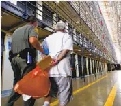  ?? Gary Coronado Los Angeles Times ?? A DEATH row inmate returns to his cell after spending time in the yard at San Quentin State Prison.