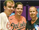  ?? KEVIN RICHARDSON/BALTIMORE SUN ?? Orioles catcher Adley Rutschman, center, poses with fans who came out to meet and bowl with players as the team’s Birdland Caravan made a stop in College Park on Saturday.