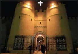  ?? KHALIL HAMRA — THE ASSOCIATED PRESS FILE ?? Clergymen walk through the gate of the historic al-Muharraq Monastery, a centuries-old site in the province of Assiut, Egypt.