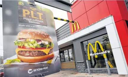  ?? MOE DOIRON • REUTERS ?? A sign promoting Mcdonald’s P.L.T. burger with a Beyond Meat plant-based patty is seen at one of 28 test restaurant locations in Ontario in 2019.