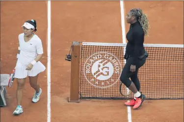  ?? ALESSANDRA TARANTINO — THE ASSOCIATED PRESS ?? Serena Williams of the U.S. walks to her bench after defeating Kristie Ahn of the U.S., left, in the first round match of the French Open tennis tournament at the Roland Garros stadium in Paris, France, Monday.