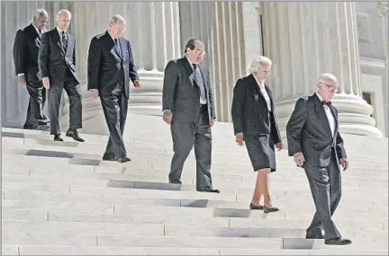  ?? Andrew Councill AFP/Getty Images ?? FUNERAL FOR A CHIEF JUSTICE Justices John Paul Stevens, from right, Sandra Day O’Connor, Antonin Scalia, Anthony M. Kennedy, David H. Souter and Clarence Thomas exit the Supreme Court, ahead of the casket of William H. Rehnquist, in September 2005. Stevens retired five years later.