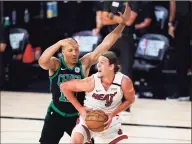  ?? Mark J. Terrill / Associated Press ?? The Miami Heat’s Kelly Olynyk (9) looks for an opening to the basket as the Boston Celtics’ Grant Williams defends during the first half of an NBA conference final playoff game on Sept. 15 in Lake Buena Vista, Fla.