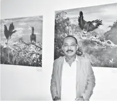  ??  ?? Muyang poses infront of his artwork entitled ‘The Land Of The Hornbills’ at Wesberly House.