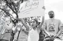  ?? Sam Owens / Staff file photos ?? Adelina Favela, 8, attends an abortion rights rally in October at Milam Park in downtown with her father Leonard Favela, right.