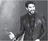  ?? Getty Images ?? Darren Criss accepts the outstandin­g lead actor in a limited series or movie award.