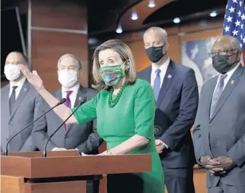  ?? J. SCOTT APPLEWHITE/AP ?? House Speaker Nancy Pelosi, D-Calif., meets with reporters Friday before a planned House vote on a $1.9 trillion pandemic relief package. Republican­s have lined up against the plan, calling it overpriced and wasteful.