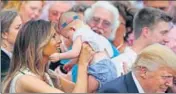  ??  ?? Melania Trump holds a baby at a White House event.