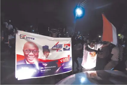  ?? Photo: Nampa/AFP ?? Victorious… Supporters celebrate with placards after President Nana Akufo-Addo’s reelection on 9 December in Accra.