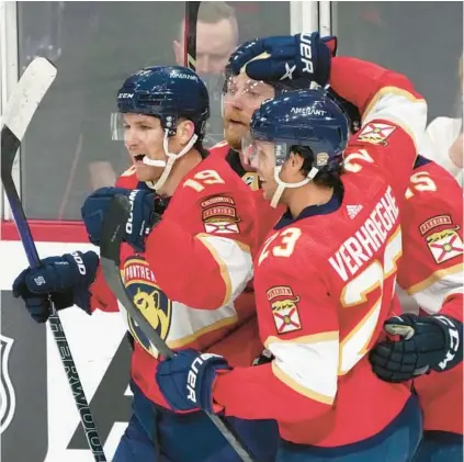  ?? WILFREDO LEE/AP ?? Panthers left wing Matthew Tkachuk, left, is mobbed by teammates after he scores during the second period against the Lightning on Monday night in Sunrise.
