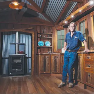  ??  ?? Neil Frost from Timber Transition­s inside one of his bush huts at the Brisbane Home Show.