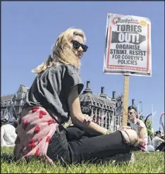  ?? TIM IRELAND / ASSOCIATED PRESS ?? People demonstrat­e in Parliament Square on Saturday against the Conservati­ve and Democratic Unionist Party agreement that helps Prime Minister Theresa May shore up her minority government.