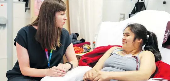  ?? JOHN MAHONEY ?? Teacher Sarah Adair works with Bryanna Frank at the Montreal Children’s Hospital. The hospital has five school teachers for elementary and high school patients.