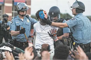  ?? VICTOR J. BLUE/THE NEW YORK TIMES ?? Police detain a protester May 31 in Minneapoli­s, where some federal and local officials blamed outsiders for stoking chaos.